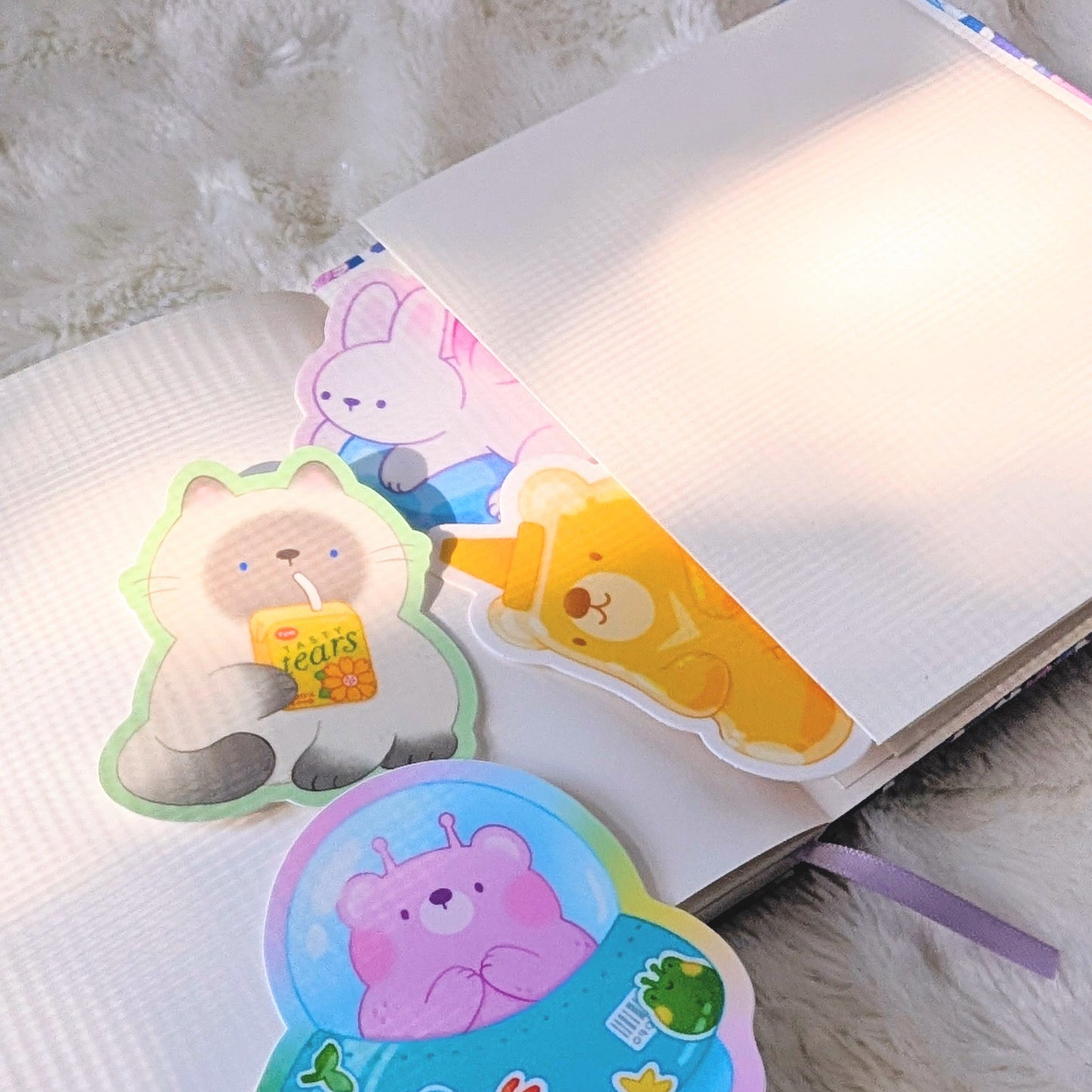 Colorful animal-shaped stickers on a book with a soft white background