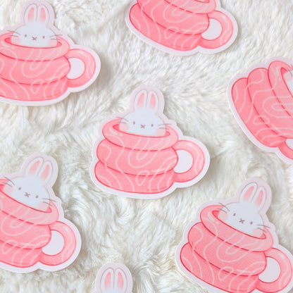 Stickers of bunnies in hot chocolate cups on a textured white background