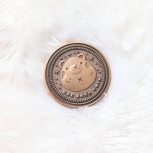 Load image into Gallery viewer, A photo of the front side of a coin made from zinc alloy with an antique gold finish. The coin features a bear in the middle and sparkle details around it. Under the bear it reads &quot;One Ruka Coin&quot;.
